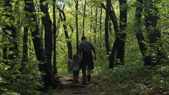mom and child walking in woods We Are Wildness